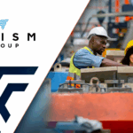 Two people wearing hardhats in factory environment.