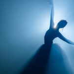 Silhouette of ballerina with light behind her.